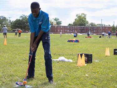 Student golfing